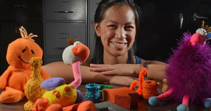 Picture of a researcher behind some toys.